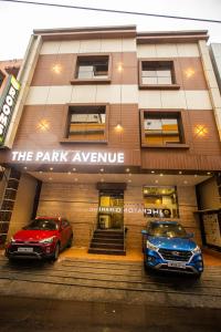 two cars parked in front of a parking garage at THE PARK AVENUE HOTEL - Business Class Hotel Near Central Railway Station Chennai Periyamet in Chennai