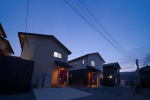 a group of houses in a street at dusk at Takanoya Tsuki - Vacation STAY 91942 in Yufuin