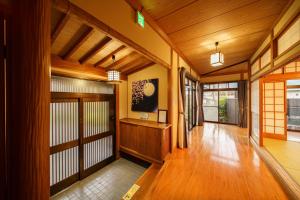 a hallway with wooden floors and doors in a building at Yumeguri no yakata Yoshinozakura - Vacation STAY 83043v in Yufuin