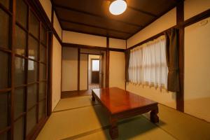 a room with a wooden table and a window at Yufuin Ekimae Yado Kachofugetsu - Vacation STAY 88189v in Yufuin