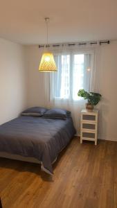 um quarto com uma cama e um vaso de plantas em Jolie appartement proche bords de Loire em Orléans