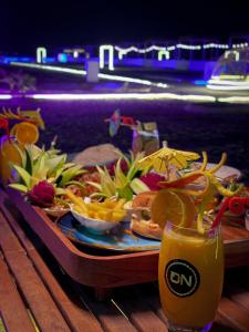 a tray of food on a table with a drink at AVICENNIA BEACH DOMES in Salalah