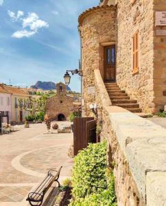 a bench sitting next to a stone building at Villa ALISA avec piscine privée in Roquebrune-sur-Argens