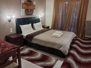 A bed or beds in a room at Erodios Guesthouse