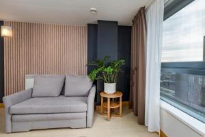 a living room with a couch and a window at Urban Oasis: Heart of City by Train in Leeds