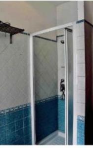 a shower with a glass door in a bathroom at St peter wiew in Rome