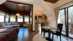 a kitchen and living room with a table and a couch at Alfinio Villa in Sinaia