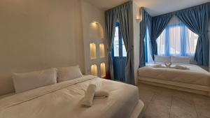 Voodi või voodid majutusasutuse Ipoh Santorini Hideaway - Hotel Inspired toas