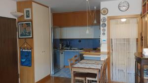 a kitchen with blue cabinets and a table and chairs at Il Girasole in Milan