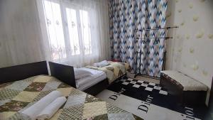 Postel nebo postele na pokoji v ubytování Гостевой дом Datka