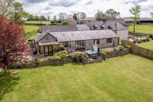 an aerial view of a house with a yard at Holgates Cottage Countryside Retreat in Upottery