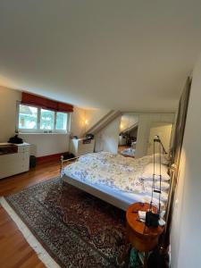 a bedroom with a large bed and a table at Spacious and stylish Apartment in Zurich in Zürich