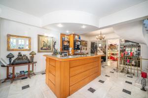 a kitchen with a large wooden counter in a room at Odysseus Palace in Poros