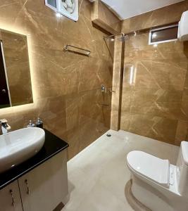 a bathroom with a toilet and a sink and a shower at CityView Homestay in Imphal +7 photos