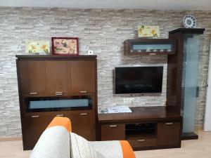 a living room with a tv and a entertainment center at PISO XUNQUEIRA in Viveiro