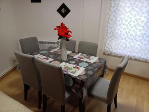 Una mesa de comedor con un jarrón de flores encima. en PISO XUNQUEIRA, en Viveiro 5 fotos más