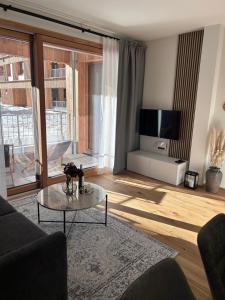 a living room with a couch and a table at Almappartement Nassfeld- Sonnenalpe in Sonnenalpe Nassfeld