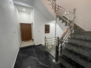 a staircase in a building with a wooden door at Rukmani Villas Group of Rukmani home stay in Mathura