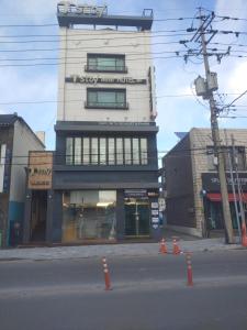 a building with a sign on the side of a street at T stay guesthouse in Cheongju