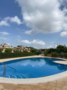 une grande piscine bleue avec un ciel nuageux dans l'établissement Apartamento Calasparra en Valle del sol, à Calasparra