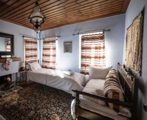 a bedroom with two beds and two windows at Gorianades Traditional House in Gorianádhes