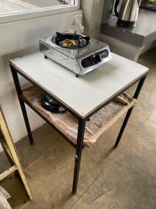 a toaster oven sitting on top of a table at Upland Inn in Kandy