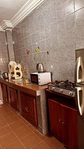 a kitchen with a stove and a counter top at Peaceful home in Yaoundé