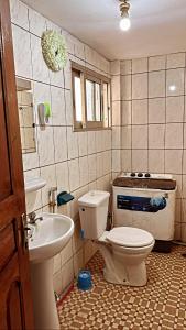 a bathroom with a toilet and a sink at Peaceful home in Yaoundé