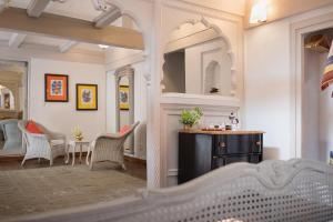 a room with a mirror and a table with chairs at Ahilya Fort in Maheshwar