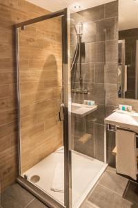 a shower with a glass door in a bathroom at Holiday Inn Budapest-Budaörs, an IHG Hotel in Budaörs