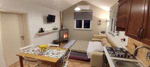 a small room with a bed and a kitchen with a table at La Tana del Berü in Varazze