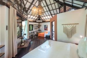 a bedroom with two beds and a living room at kawayan villa siargao in General Luna
