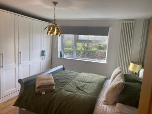 a bedroom with a bed and a window at Lambley view 