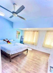 a bedroom with a bed and a ceiling fan at Free & Easy Leisure Homestay in Batu Caves