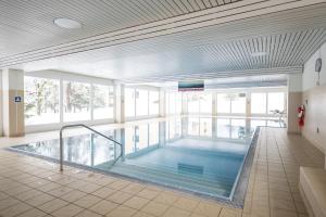 a large swimming pool in a building at Brentschpark 28 in Scuol
