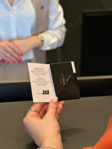 a person holding up a piece of black paper at Diamond Resort White in Bukovel