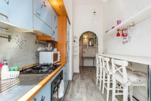 a kitchen with a stove and some white cabinets at Rome sweet home in Rome