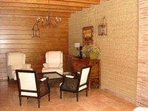a dining room with a table and four chairs at Hotel Villa de Canfranc in Canfranc-Estación