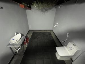 a bathroom with a sink and a toilet at The Goko Social in Gokarna