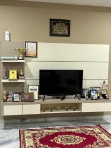 a entertainment center with a flat screen tv on top at Homestay Hajrah in Ipoh