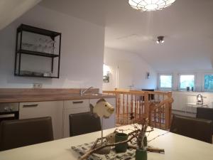 eine Küche mit einem Tisch und einem Esszimmer in der Unterkunft Fischstuebchen Neeberg in Krummin
