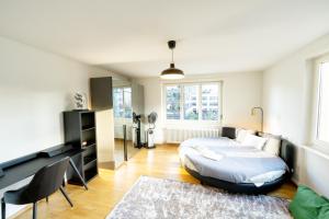 a bedroom with a bed and a table and chairs at Loving apartment right in the heart of Zurich! in Zurich