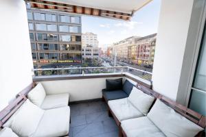 a balcony with couches and a view of a city at Loving apartment right in the heart of Zurich! in Zurich