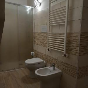 a bathroom with a toilet and a sink and a shower at Dream House Castellana in Castellana Sicula