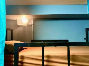 a bed in a room with avertisement at Black Pantera Hostel in Patong Beach