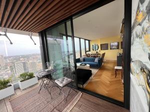 a living room with a view of a city at Sydney Cosmopolitan CBD Apartment in Sydney