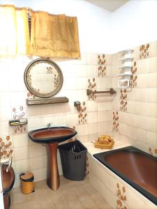 a bathroom with a sink and a bath tub at Locamarre G GONDET in Sainte-Anne