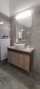 a bathroom with a sink and a mirror at Parthenon View Apt in Athens