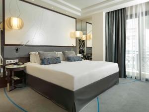 a large bedroom with a large bed in a room at Sofitel Beirut Le Gabriel in Beirut