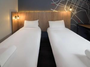 Postel nebo postele na pokoji v ubytování ibis Curitiba Batel